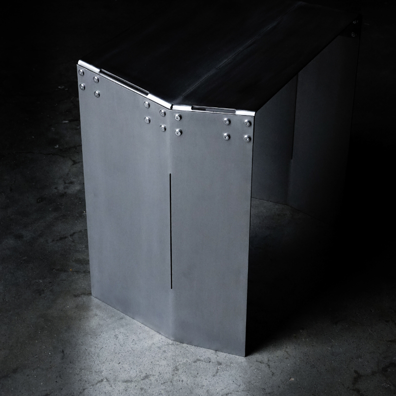 Metallic bench with riveted details on a dark background